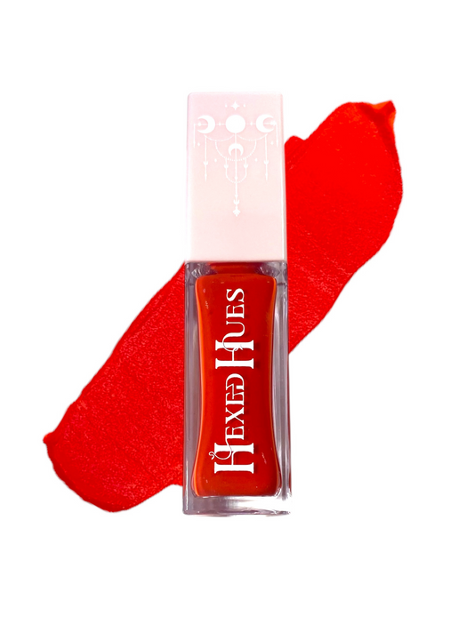 Red hexed hue blush bottle with a color swatch behind it on a white background